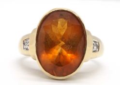 A 9ct citrine ring, the oval golden citrine in a rubover mount and deep gallery, with ridged tapered