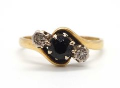 An 18ct sapphire and diamond crossover style ring, the central round sapphire with an illusion