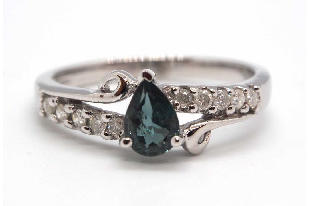 An 18ct white gold diamond and blue-green stone ring, the central blue-green pear shape stone set - Image 1 of 4
