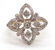 A 9ct diamond ring, the openwork quatrefoil style ring set throughout with small round diamonds with