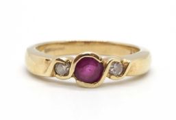 A 9ct ruby and diamond ring, the round collet mounted ruby with a round brilliant cut diamond to