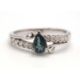 An 18ct white gold diamond and blue-green stone ring, the central blue-green pear shape stone set - Image 2 of 4