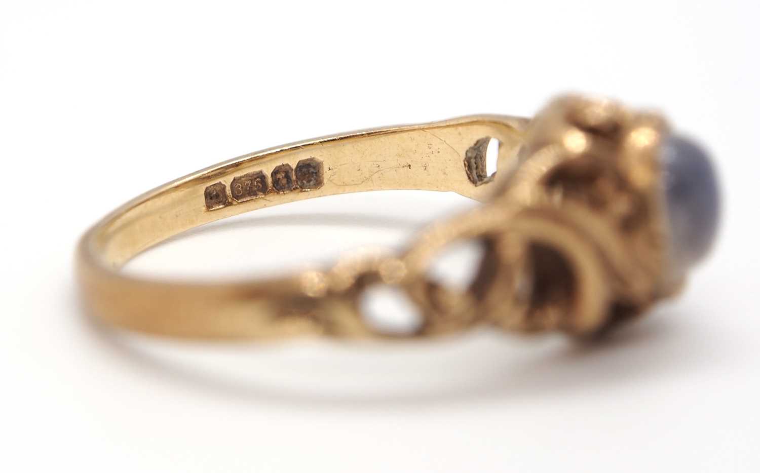 A 9ct moonstone ring, the round moonstone cabochon in a rubover mount with scrolled surround - Image 5 of 5