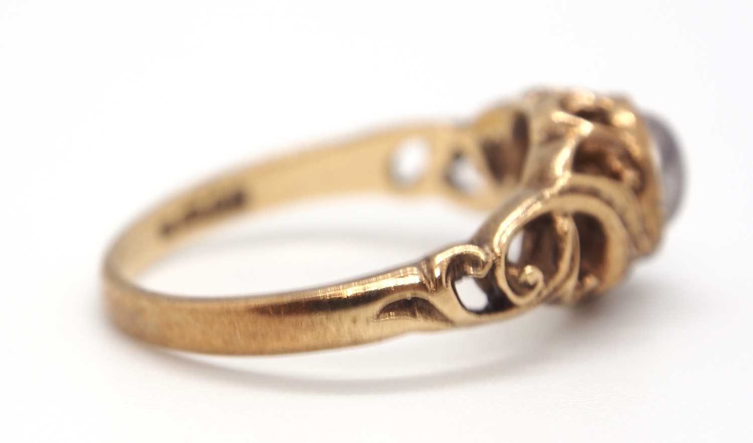 A 9ct moonstone ring, the round moonstone cabochon in a rubover mount with scrolled surround - Image 3 of 5