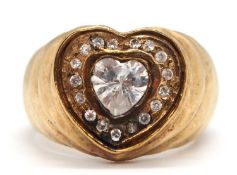 A 9ct heart shape ring, set with a central heart shape CZ and surrounded by small white stones, with