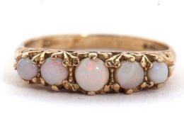 A 9ct opal ring, set with five graduated round opal cabochons, claw mounted with scrolled gallery