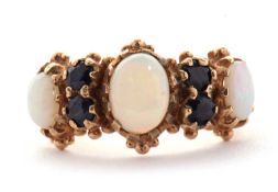 An opal and sapphire ring, the three slightly graudated oval opals, interspaced with two round