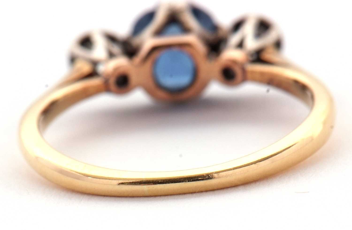 A sapphire and diamond ring, the central pale blue sapphire set to either side with an illusion - Image 4 of 6