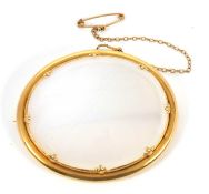 An agate brooch, the oval pale white agate specimen in an unmarked yellow metal mount, (tests as