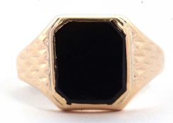 A 9ct onyx ring, the squared onyx in rubover mount with tapered shoulers with diamond pattern, plain