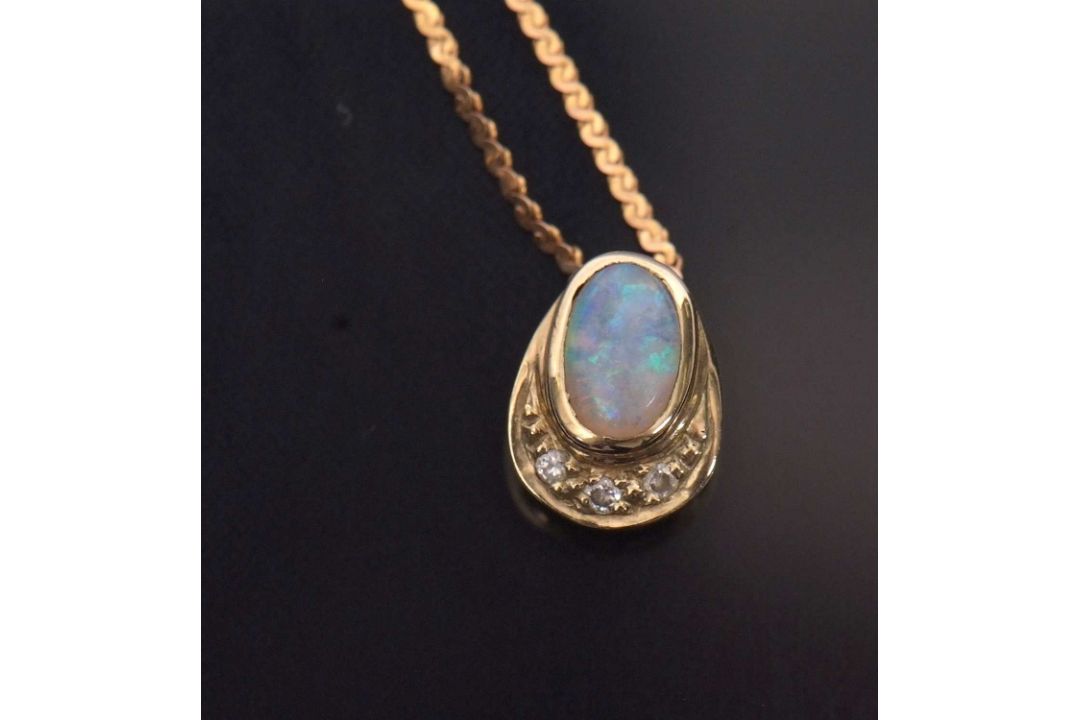 A 9ct opal and diamond pendant necklace, the oval opal cabochon in a pear shape mount with diamond - Image 2 of 4