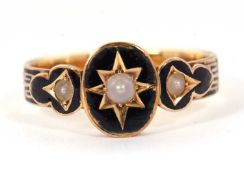 A 19th century mourning ring, the central oval panel with a gypsy set pearl surrounded by black