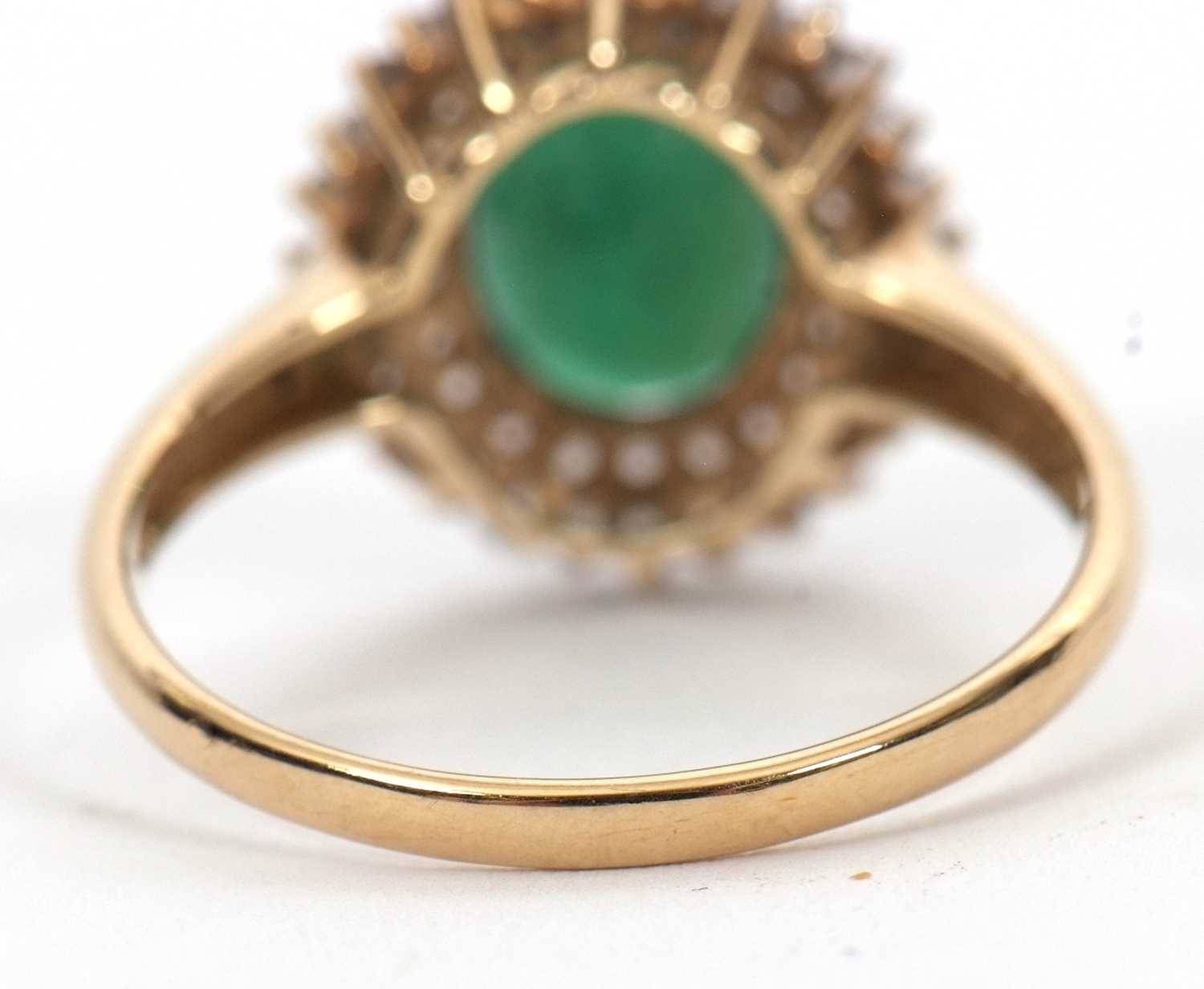 A 9ct emerald and diamond cluster ring, the oval emerald, approx. 9mm long, surrounded by two rows - Image 4 of 6