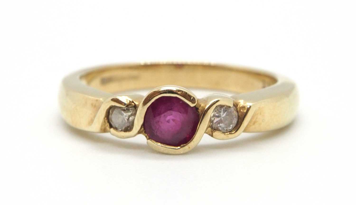 A 9ct ruby and diamond ring, the round collet mounted ruby with a round brilliant cut diamond to - Image 2 of 8