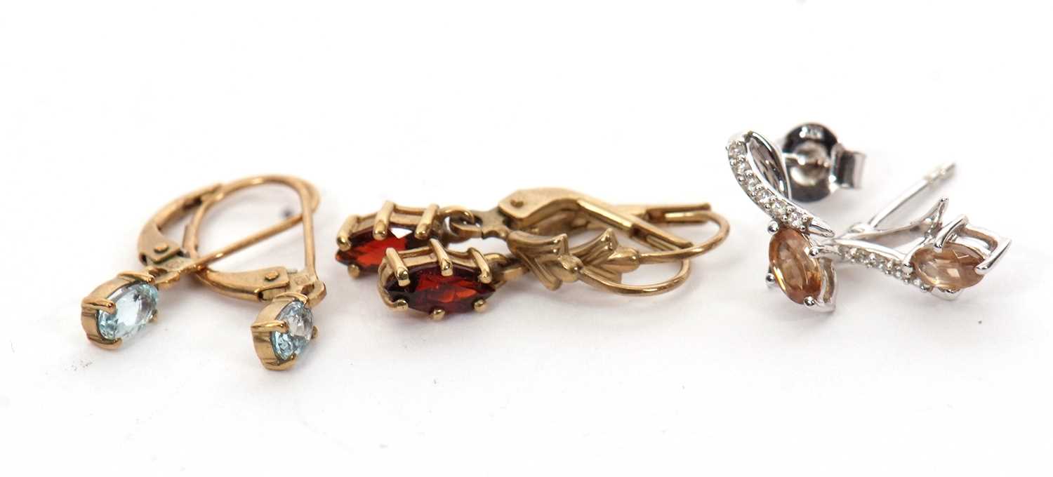 Three pairs of 9ct gemset earrings: to include a pair of marquise garnet earrings with hooks stamped