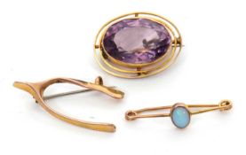 Three brooches: to include a 9ct wishbone brooch stamped 9.375 with Chester assay mark, 1.2g; an