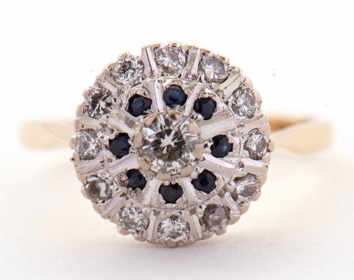 A sapphire and diamond cluster ring, the central round brilliant cut diamond surrounded by a ring of - Image 2 of 7
