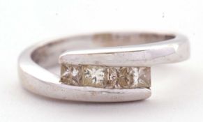An 18ct white gold four stone diamond ring, the four princess cut diamonds, total estimated