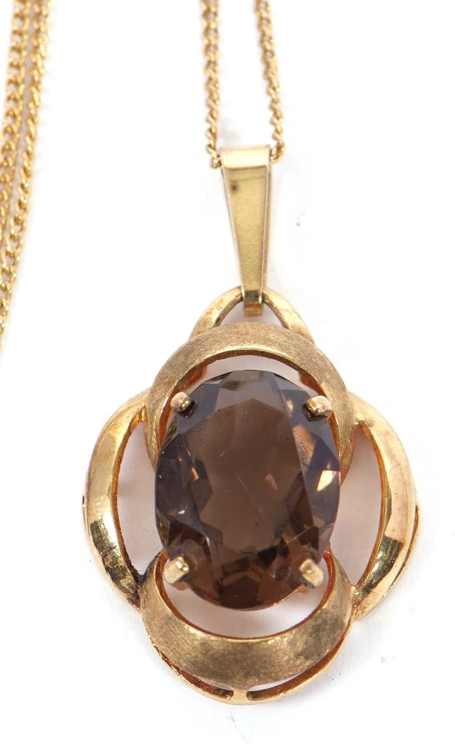 A smokey quartz pendant, the oval smokey quartz set within an openwork scalloped frame with - Image 2 of 3