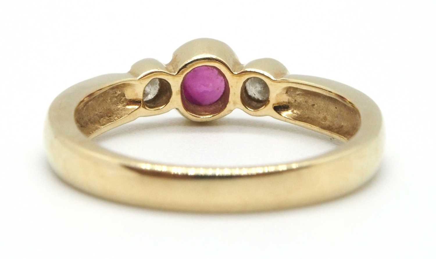 A 9ct ruby and diamond ring, the round collet mounted ruby with a round brilliant cut diamond to - Image 4 of 8