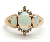 A 9ct opal and pale green hardstone ring, the cental oval opal cabochon with small round pale