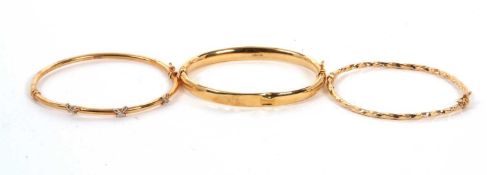 Two 9ct bangles and another: to include a 9ct hinged bangle stamped 375 with Sheffield assay mark,