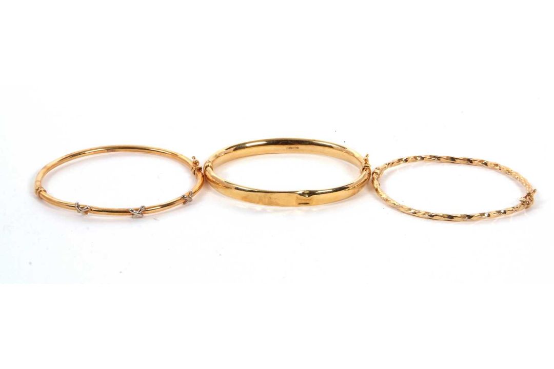 Two 9ct bangles and another: to include a 9ct hinged bangle stamped 375 with Sheffield assay mark, - Image 1 of 4