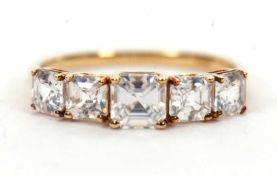 A 9ct white zircon ring, the five graduated square step cut white zircons, all claw mounted to a
