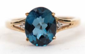 A 9ct 'London Blue' topaz and white stone ring, the oval mixed cut topaz, approx. 9.8mm long, in a