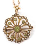 A peridot and split pearl pendant/brooch, set with a central peridot surrounded by further smaller