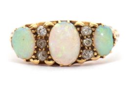An opal and diamond ring, the three slightly graduated oval opals, interspaced with thre small old