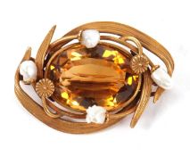 An early 20th century citrine and baroque pearl brooch, the oval collet mounted citrine surrounded