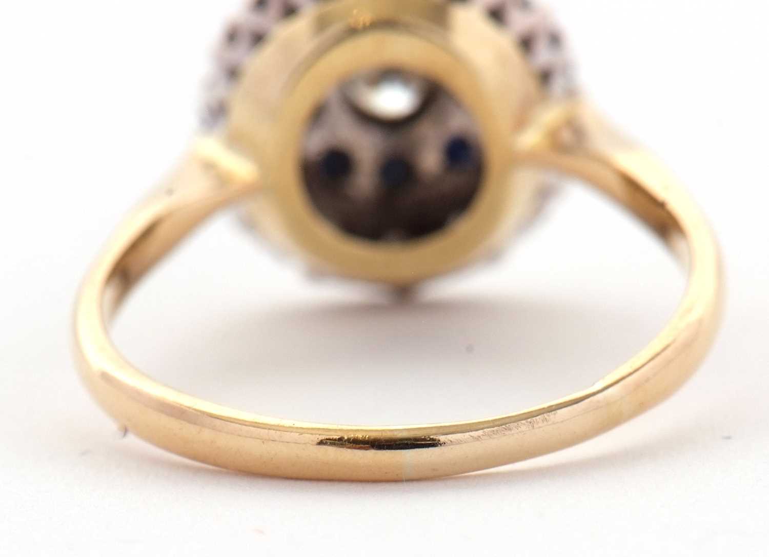 A sapphire and diamond cluster ring, the central round brilliant cut diamond surrounded by a ring of - Image 4 of 7