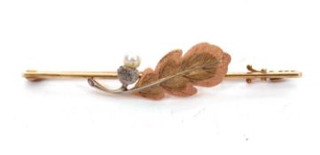 A 15ct and 18ct cultured pearl oak leaf brooch, set with a bi-colour gold oak leaf with a cultured