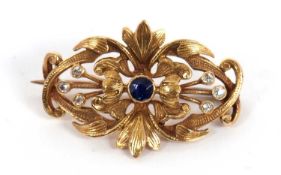 A 14ct sapphire and diamond brooch, the central round sapphire surrounded by foliate design set with