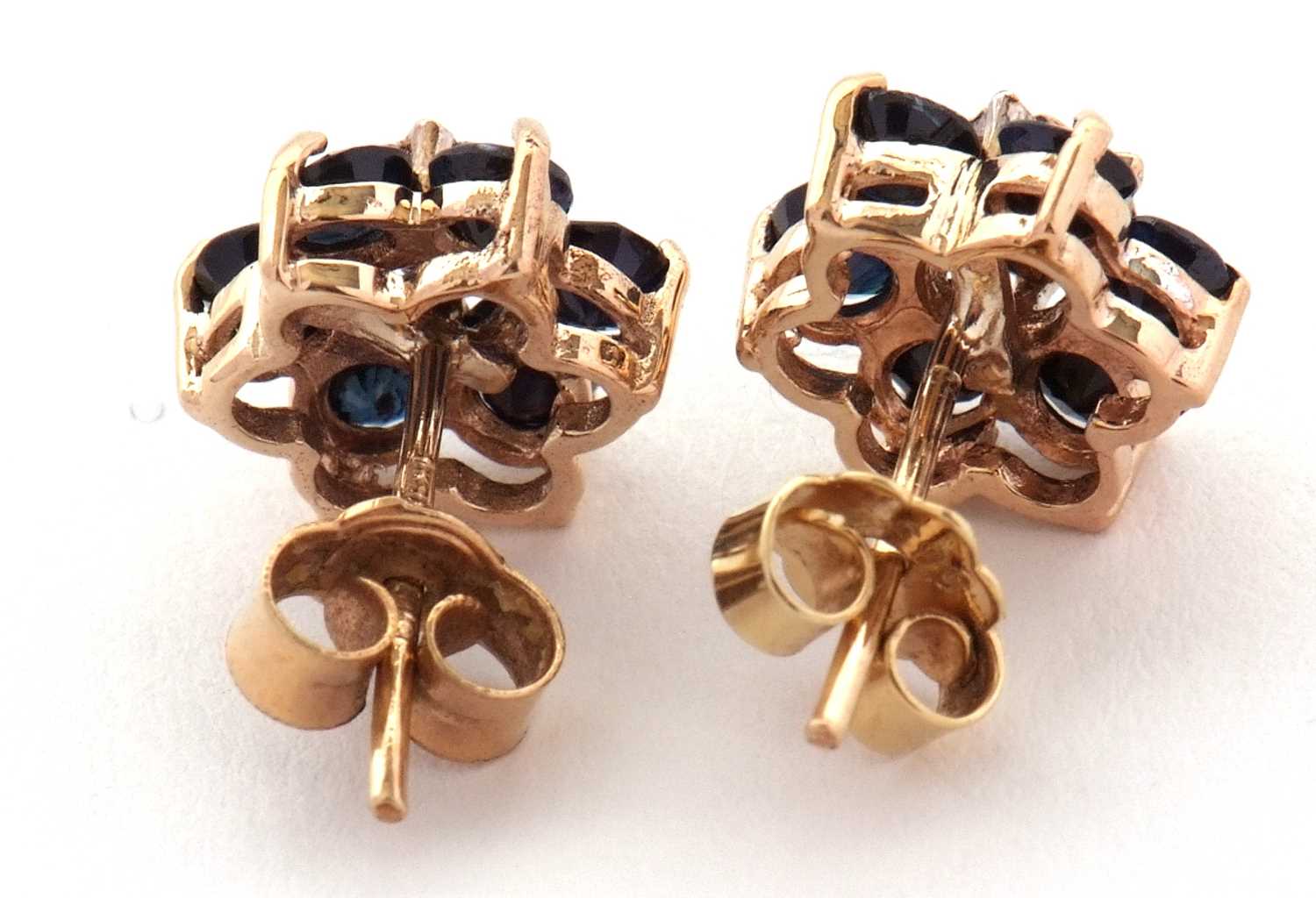 A pair of 9ct sapphire and diamond earrings, the flowerhead cluster earrings set to centre with an - Image 2 of 2