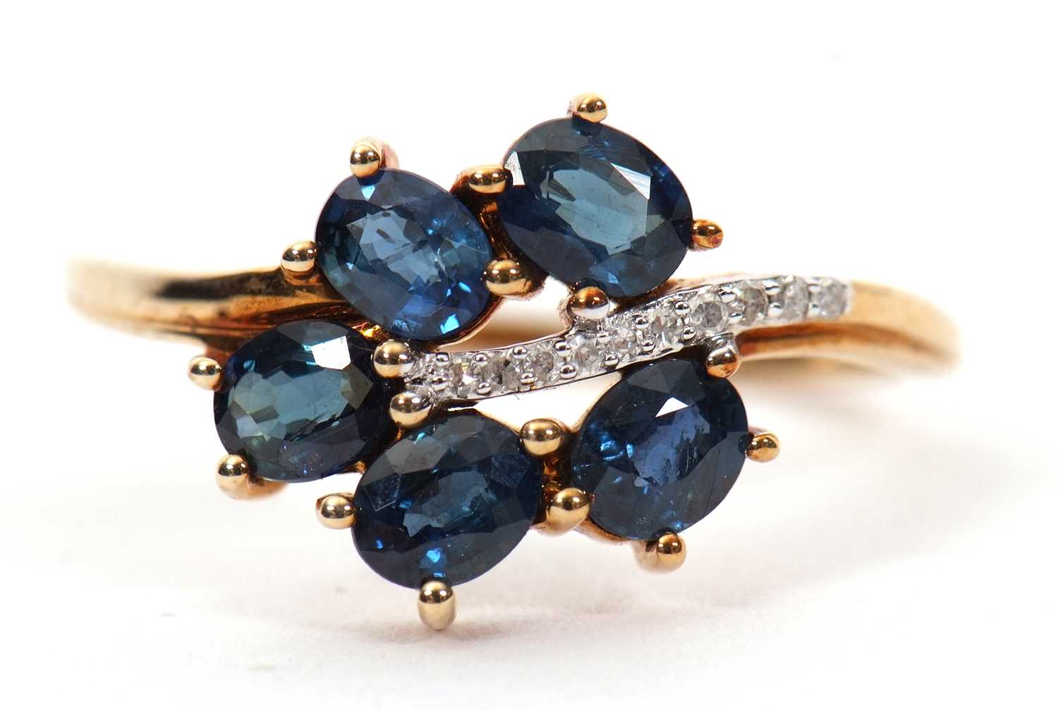A 9ct blue stone and diamond ring, the leaf shape ring set with five oval blue stones (probably