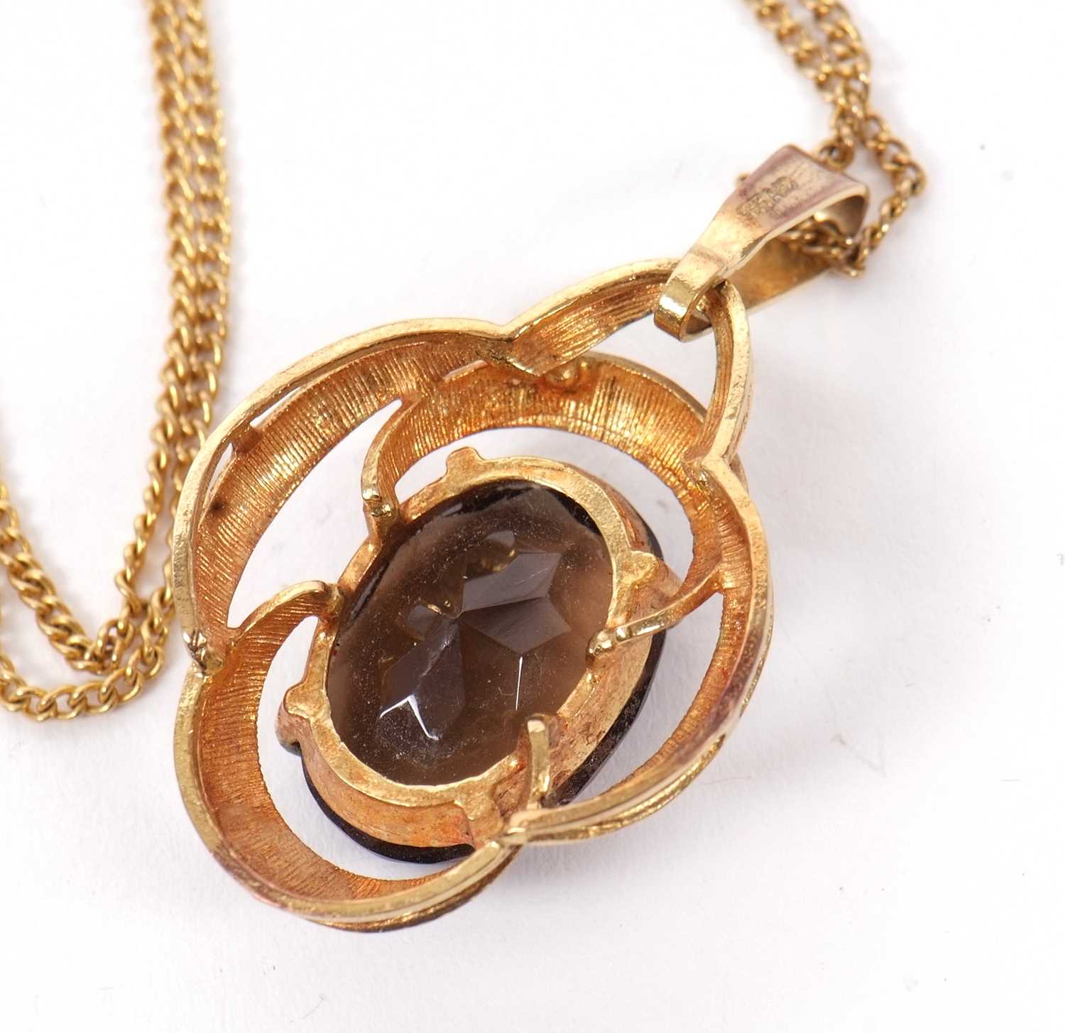 A smokey quartz pendant, the oval smokey quartz set within an openwork scalloped frame with - Image 3 of 3