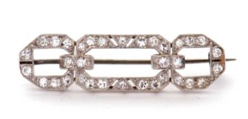 An Art Deco diamond brooch, the three panelled rectangular frame set throughout with single cut