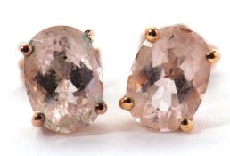 A pair of 9ct morganite earstuds, the oval studs in a four claw mount, 5mm wide, with backs