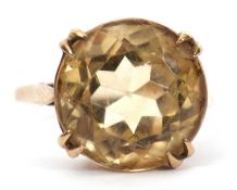 A 9ct citrine ring, the round faceted citirine, in four double claws with plain band hallmarked