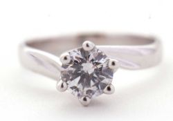 A 9ct white gold CZ ring, the round CZ, in twisted claw mount with crossover style band stamped