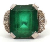 A green stone and diamond ring, the emerald cut green stone (possibly an emerald doublet) in a