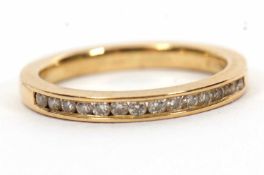 An 18ct diamond half hoop ring, channel set with small round brilliant cut diamonds, total 0.