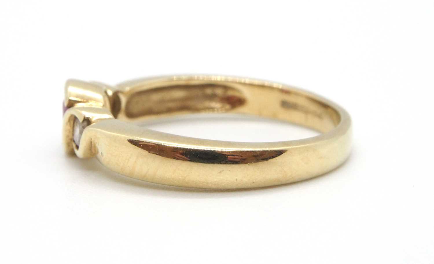 A 9ct ruby and diamond ring, the round collet mounted ruby with a round brilliant cut diamond to - Image 3 of 8