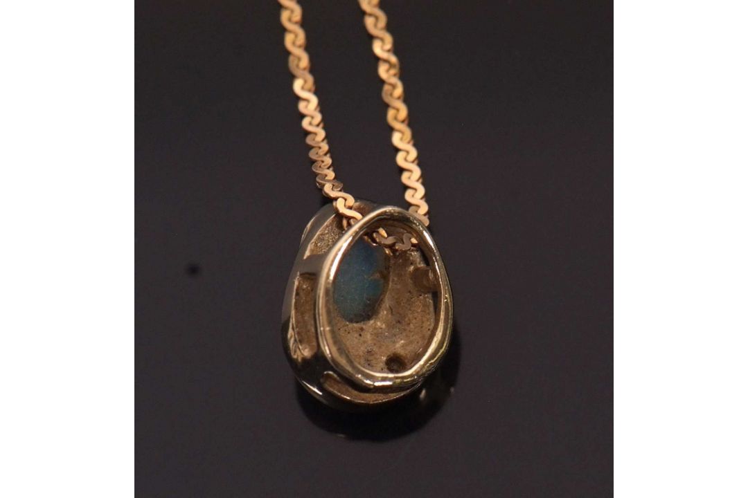 A 9ct opal and diamond pendant necklace, the oval opal cabochon in a pear shape mount with diamond - Image 3 of 4