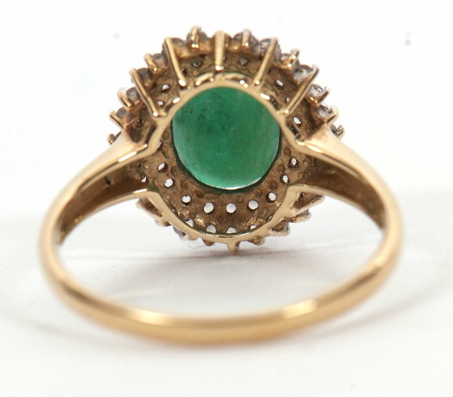 A 9ct emerald and diamond cluster ring, the oval emerald, approx. 9mm long, surrounded by two rows - Image 5 of 6