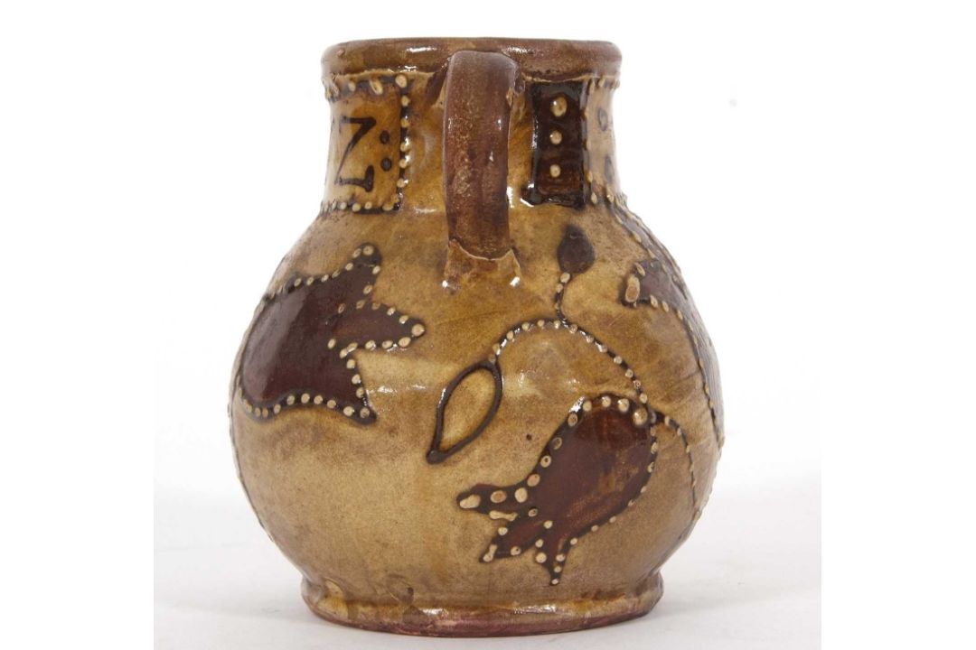An early 18th Century pottery mug, possibly Devon slip ware decorated with tulips and dated 1743, - Image 5 of 7