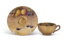 A miniature Worcester porcelain cup and saucer painted with fruit, the saucer signed R Harper and