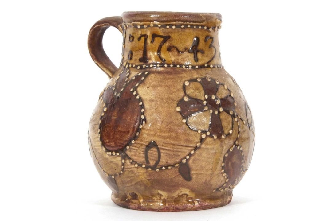 An early 18th Century pottery mug, possibly Devon slip ware decorated with tulips and dated 1743, - Image 2 of 7